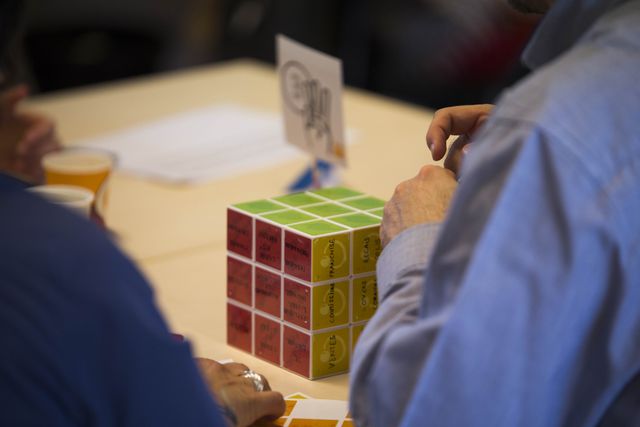 A cube whose red and yellow stickers are annotated in marker during a workshop
